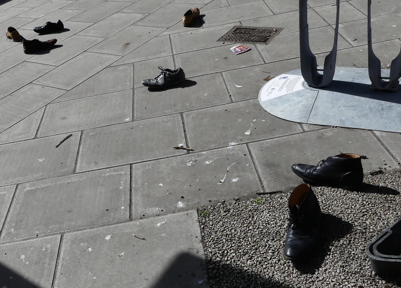 Abandoned shoes on pavement